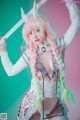 A woman with pink hair holding a sword.